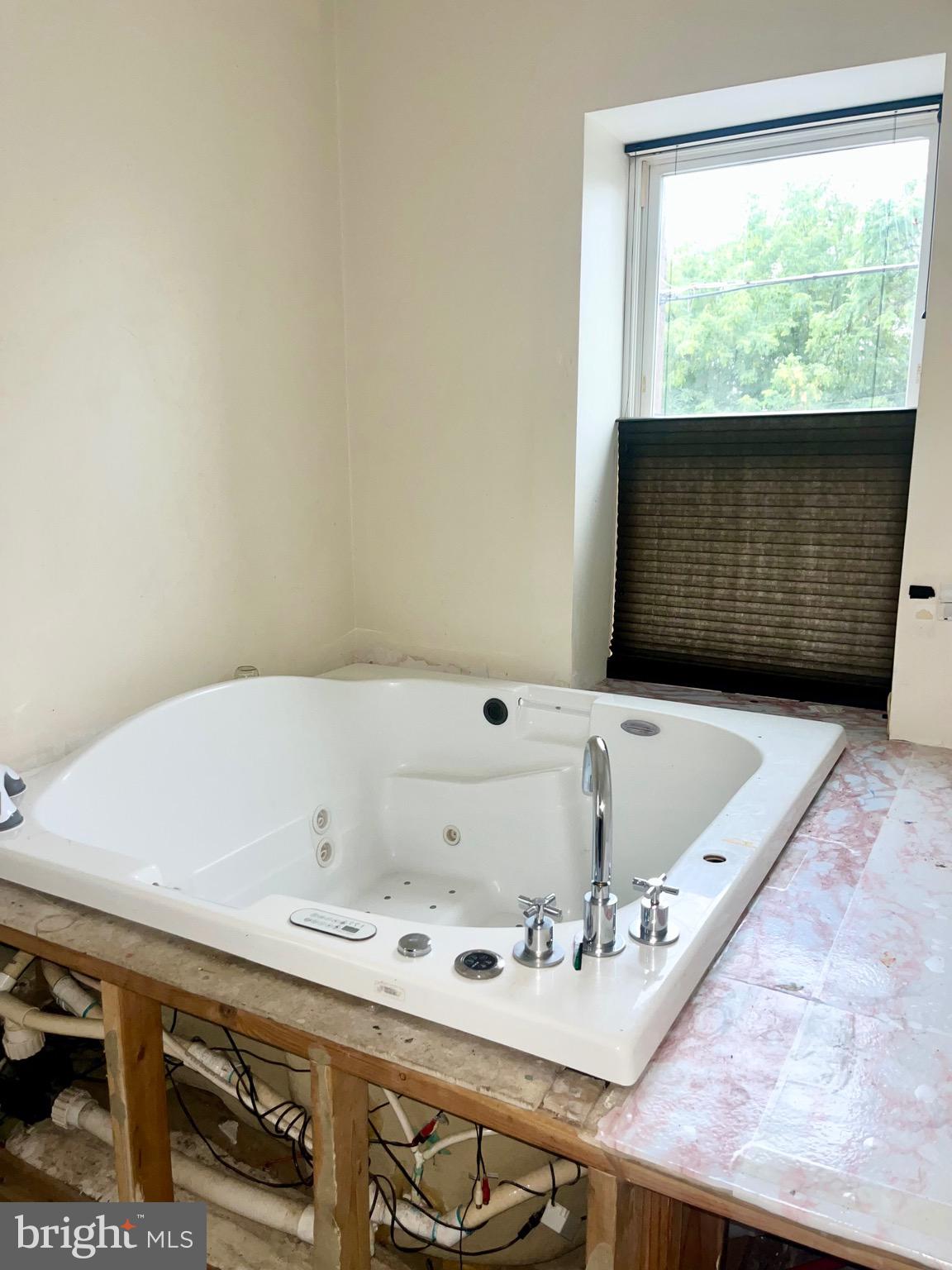 1351 Grove Street Philadelphia, PA 19146 - Photo 7 of 8 a bath tub sitting in a bathroom next to a window