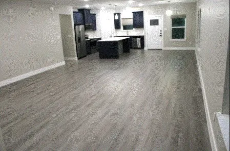 a view of kitchen with wooden floor and electronic appliances
