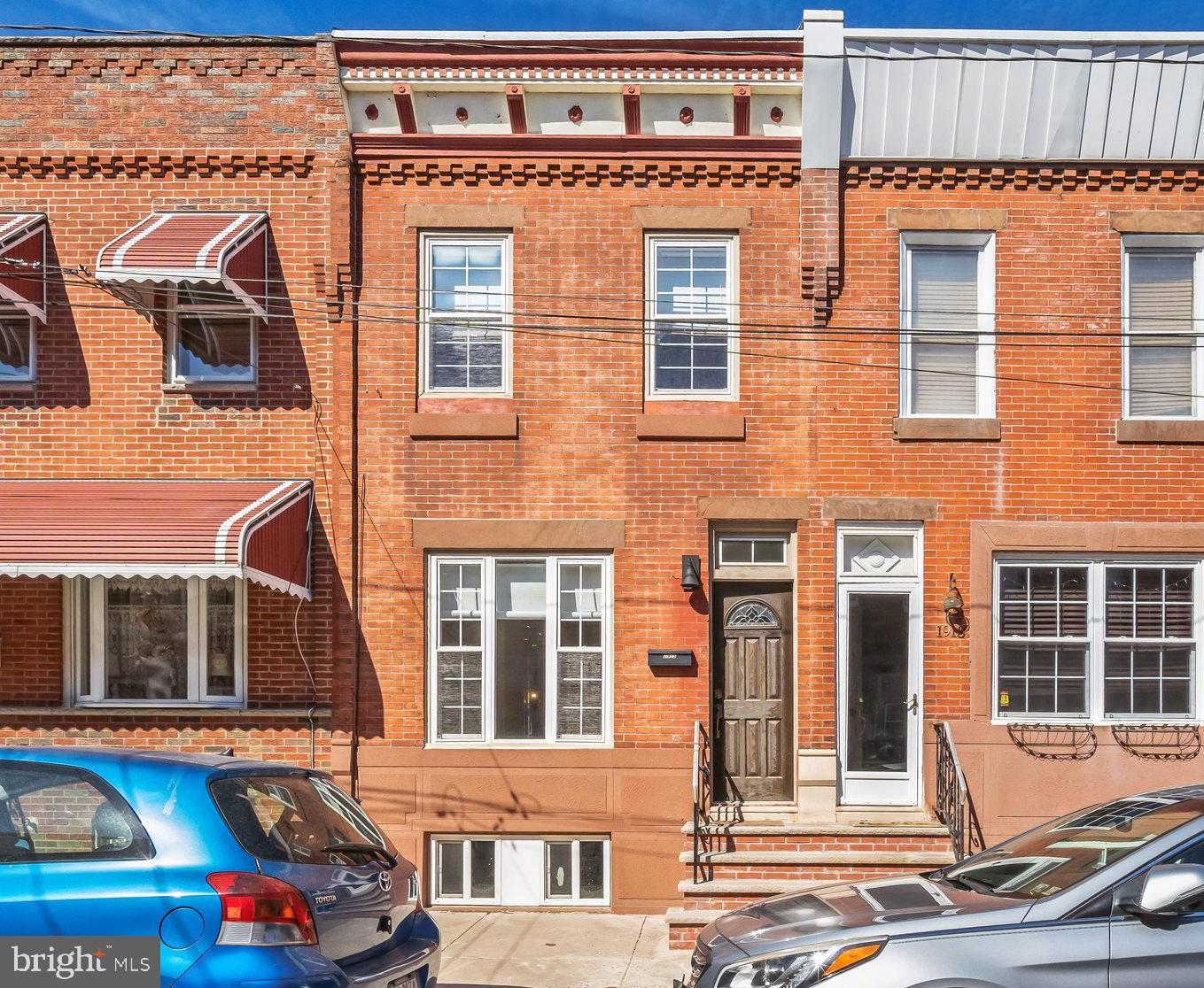 a front view of a residential apartment building with a yard