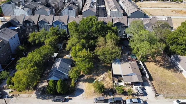 an aerial view of a house with garden space and street view