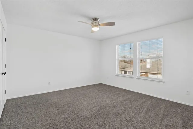 a bathroom with a granite countertop sink mirror vanity and toilet