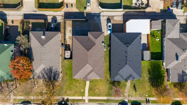 an aerial view of multiple houses with a yard