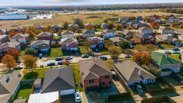 an aerial view of residential houses with outdoor space
