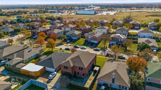 an aerial view of residential houses with outdoor space