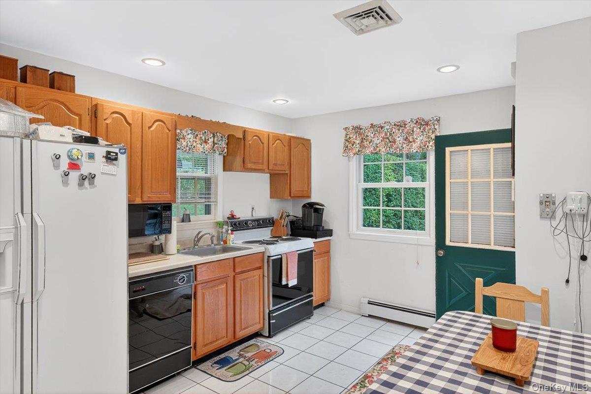 3748 Noyack Road Sag Harbor, NY 11963 - Photo 4 of 15 a kitchen with a sink appliances cabinets and a window