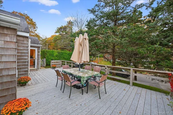 a backyard of a house with barbeque oven table and chairs