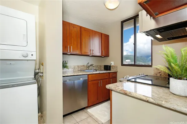 a kitchen with stainless steel appliances granite countertop a sink a stove and a refrigerator