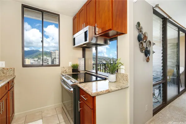 a kitchen with stainless steel appliances granite countertop a sink a refrigerator and a blue cabinets