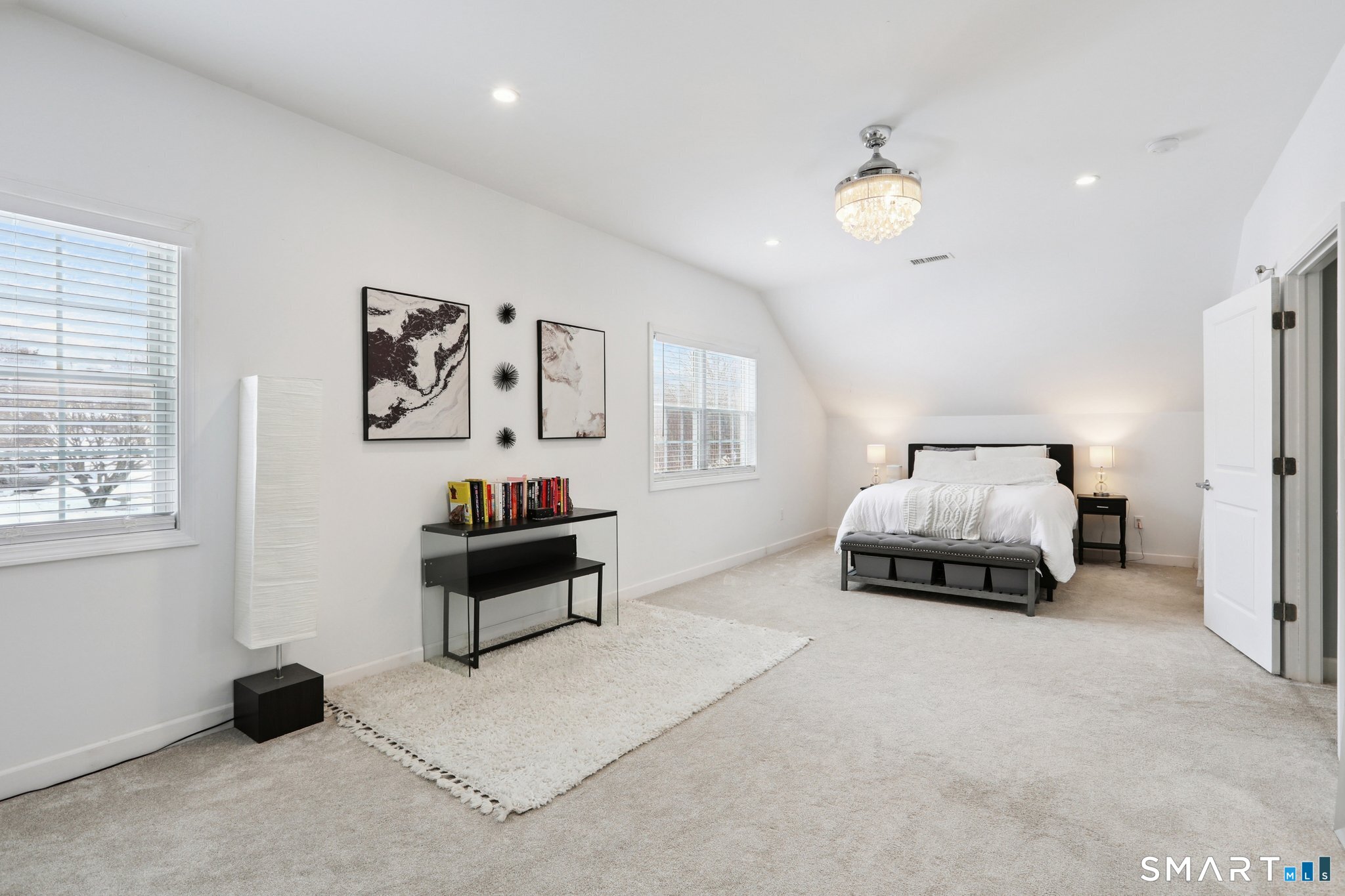 6 Ezra Road Danbury, CT 06811 - Photo 12 of 22 a bedroom with a bed and a chandelier