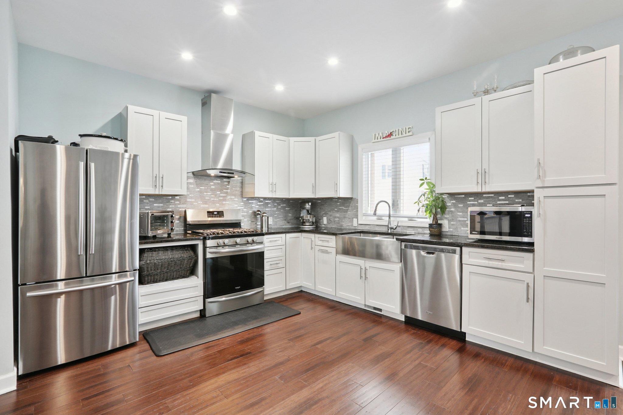 6 Ezra Road Danbury, CT 06811 - Photo 3 of 22 a kitchen with a refrigerator cabinets and wooden floor