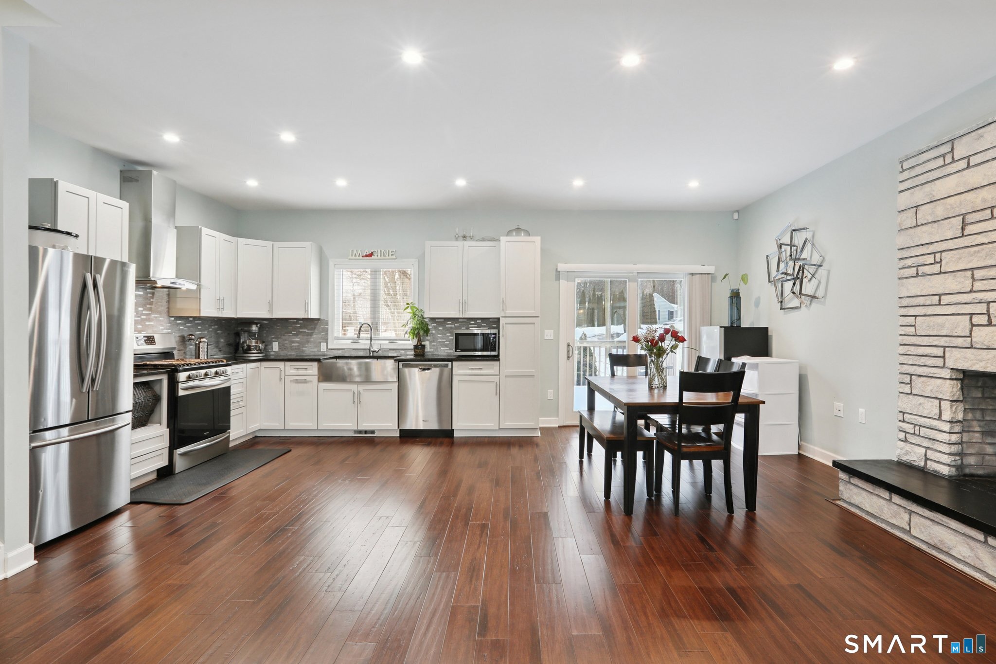 6 Ezra Road Danbury, CT 06811 - Photo 4 of 22 a kitchen with stainless steel appliances wooden floor and a refrigerator