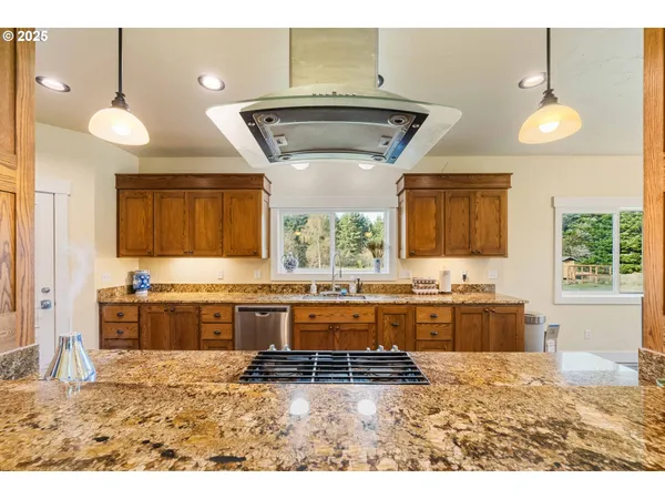 a large kitchen with kitchen island granite countertop a stove and a granite counter tops