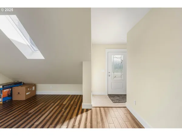 a view of bedroom with wooden floor