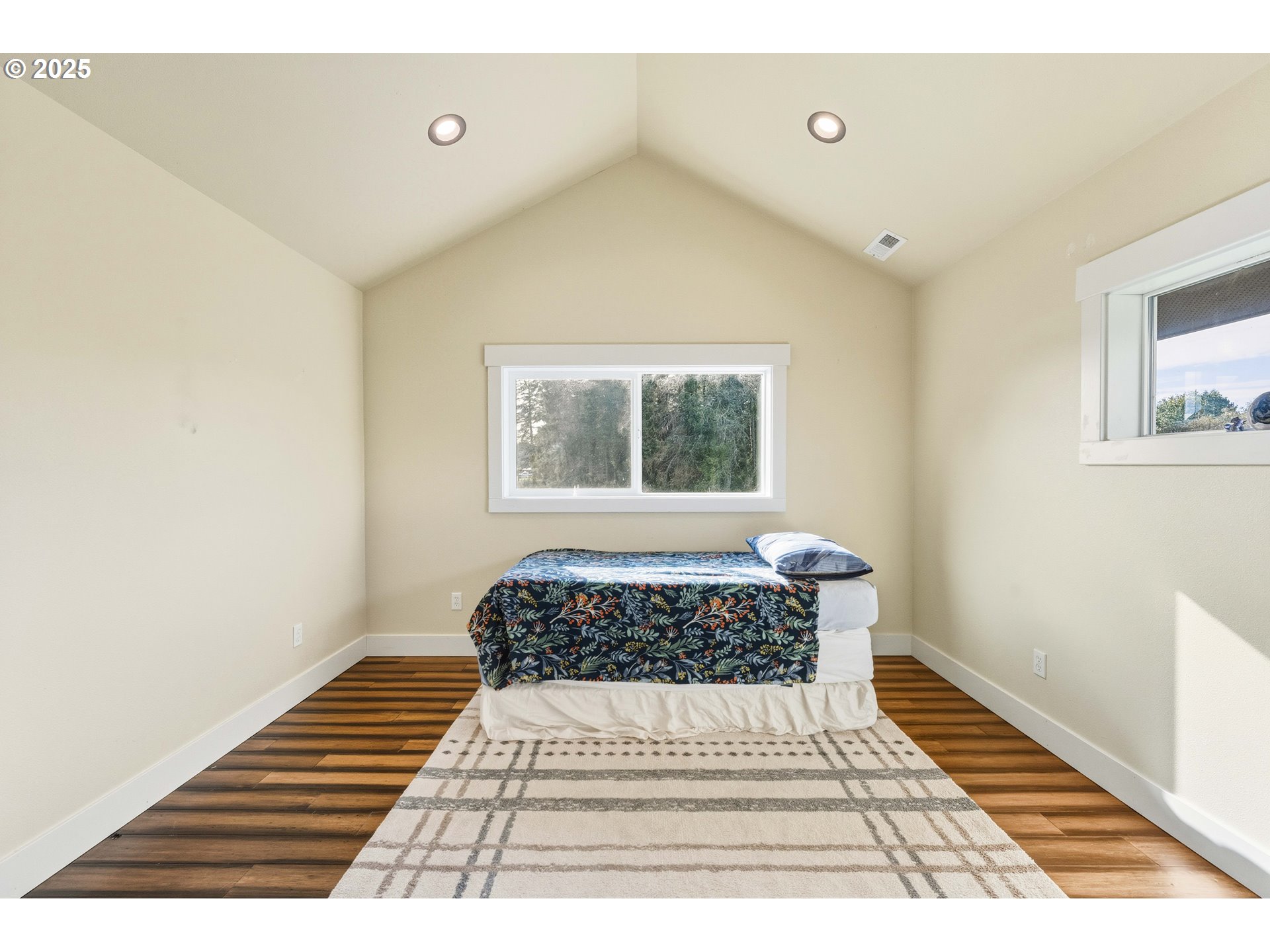 55942 Lost Valley Road Bandon, OR 97411 - Photo 32 of 48 a bedroom with a bed and a window