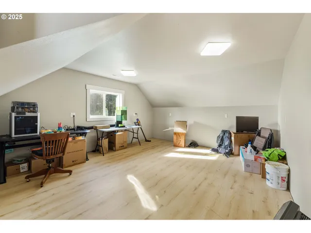 a bedroom with furniture and a wooden floor