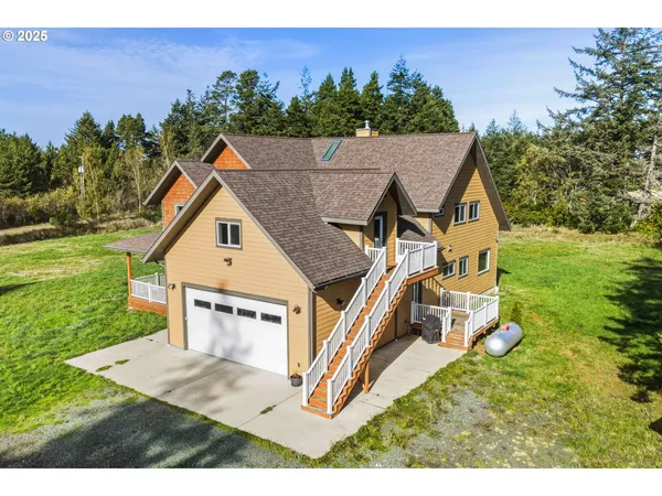 an aerial view of a house with a yard