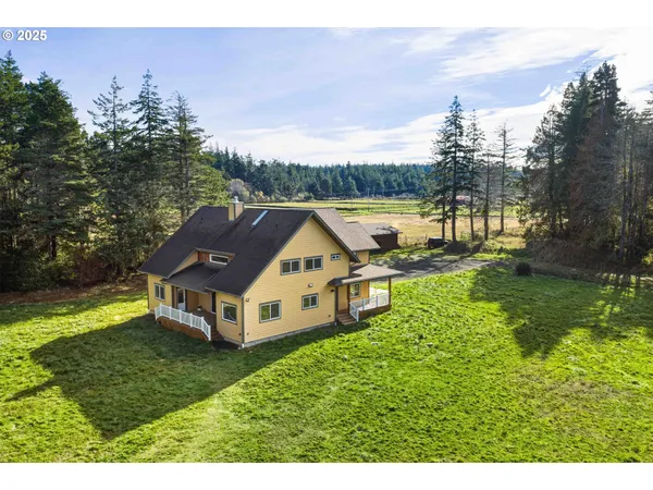a aerial view of a house with a yard