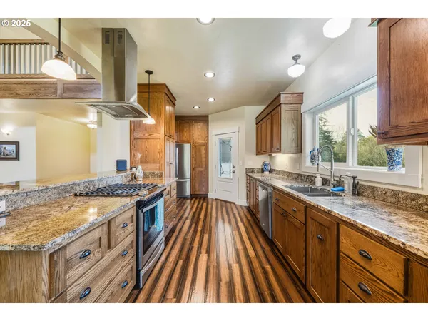 a kitchen with granite countertop a sink stove and cabinets