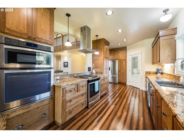 a kitchen with stainless steel appliances granite countertop a stove and a sink