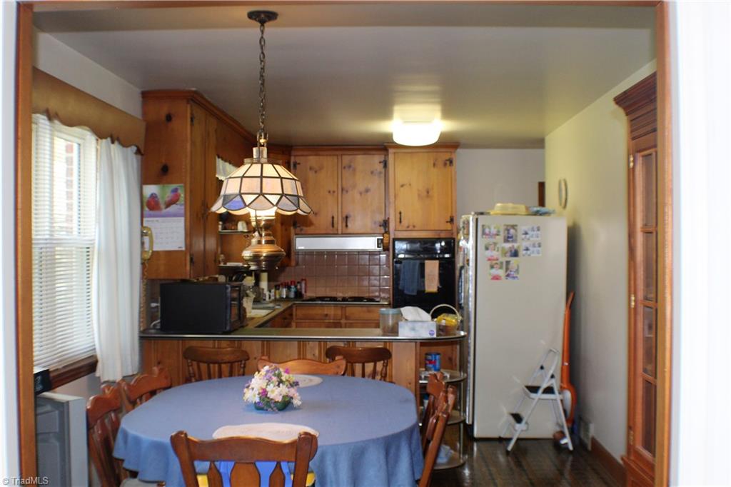 330 Oak Summit Road Winston-Salem, NC 27105 - Photo 4 of 17 Eat-In Kitchen with large windows to let the sun in. Wood Cabinets in good condition.