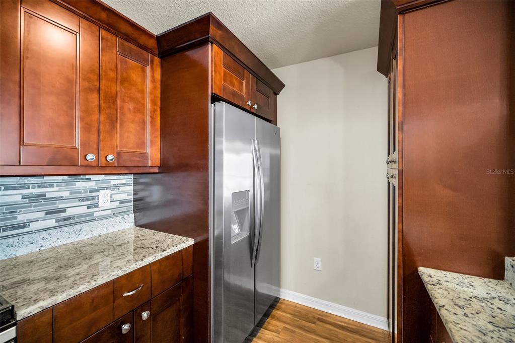 5064 Royal Palms Way, Unit 204 New Port Richey, FL 34652 - Photo 19 of 89 a kitchen with stainless steel appliances granite countertop a refrigerator and a sink