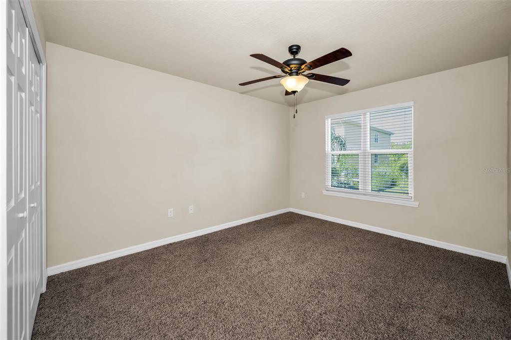 5064 Royal Palms Way, Unit 204 New Port Richey, FL 34652 - Photo 30 of 89 an empty room with a window and a fan