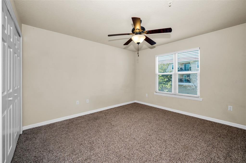 5064 Royal Palms Way, Unit 204 New Port Richey, FL 34652 - Photo 32 of 89 an empty room with a window and a fan
