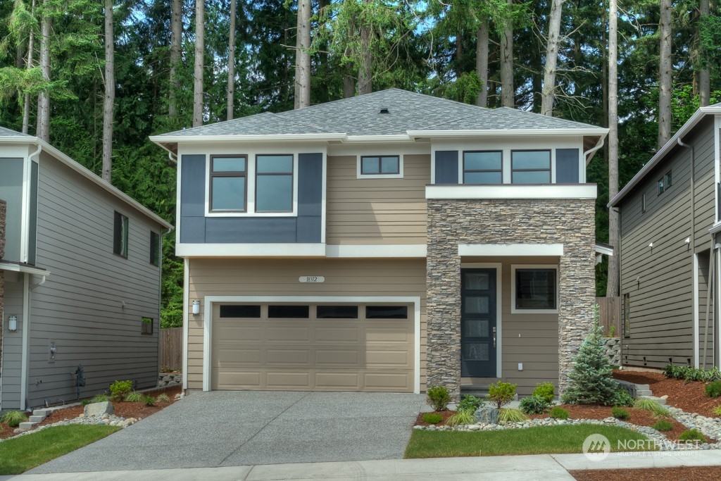 2010 228th Place Southwest, Unit 49 Bothell, WA 98021 - Photo 1 of 25 a front view of a house with a yard