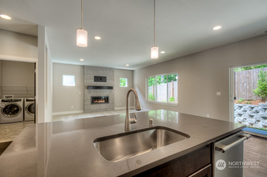 2010 228th Place Southwest, Unit 49 Bothell, WA 98021 - Photo 16 of 25 a kitchen with kitchen island a sink appliances and a counter top space
