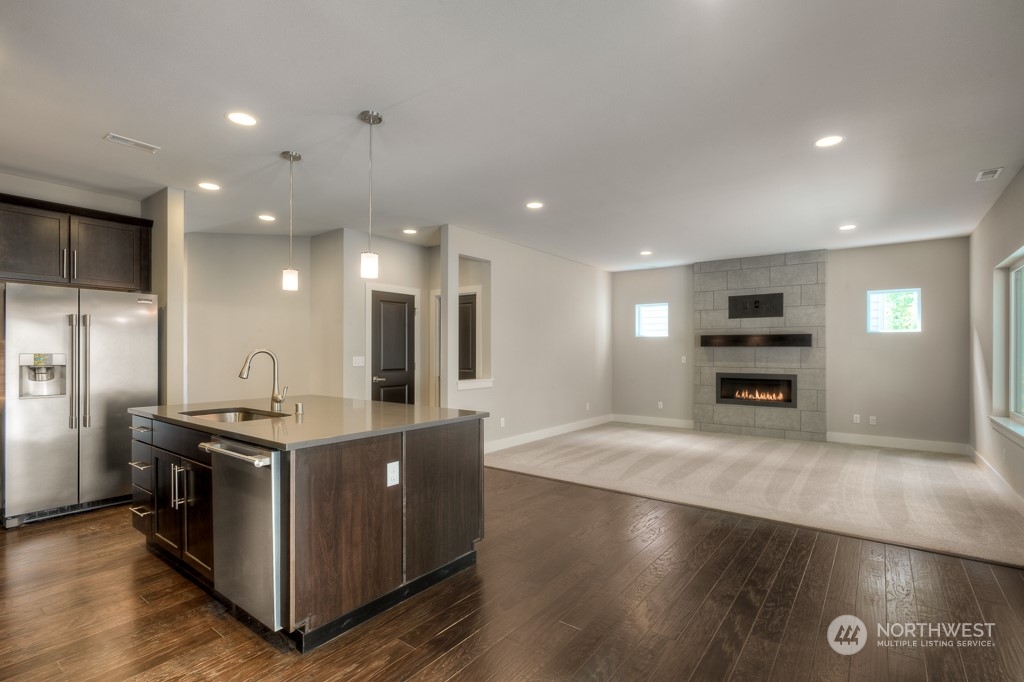 2010 228th Place Southwest, Unit 49 Bothell, WA 98021 - Photo 18 of 25 a kitchen with stainless steel appliances granite countertop a stove and a refrigerator