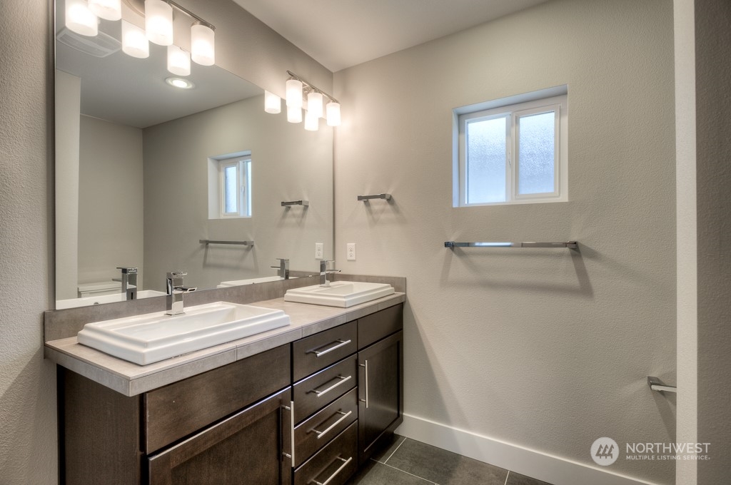 2010 228th Place Southwest, Unit 49 Bothell, WA 98021 - Photo 3 of 25 a bathroom with a sink and a mirror