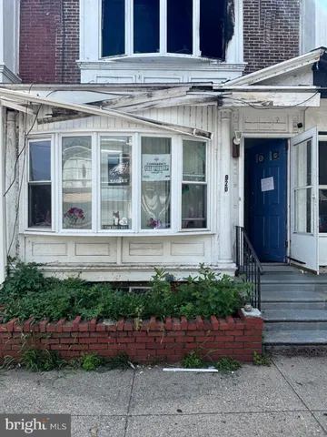 a view of brick building with potted plants