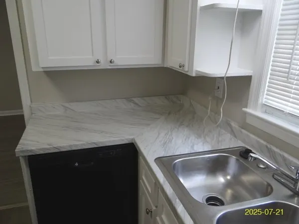 a kitchen with a sink and cabinets