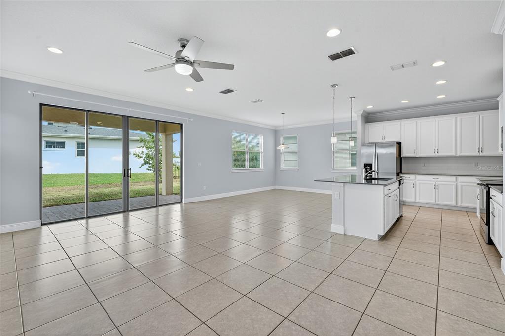 6687 Alder Road Harmony, FL 34773 - Photo 16 of 42 a view of kitchen with granite countertop cabinets and window