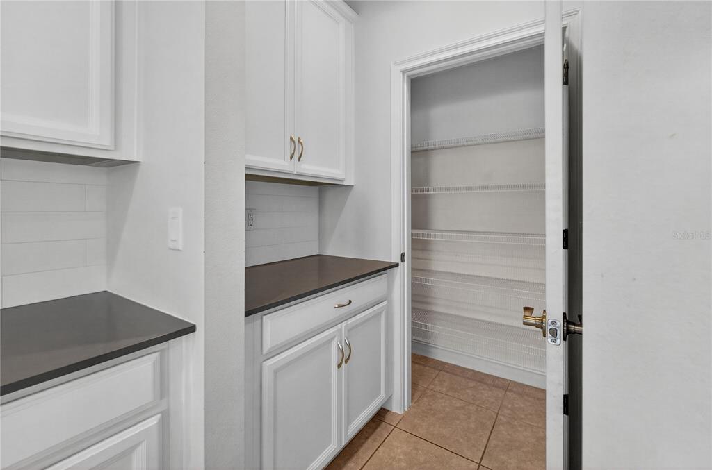 6687 Alder Road Harmony, FL 34773 - Photo 18 of 42 a kitchen with white cabinets and a sink