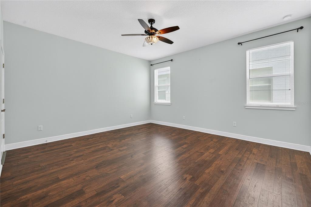 6687 Alder Road Harmony, FL 34773 - Photo 21 of 42 an empty room with wooden floor and windows