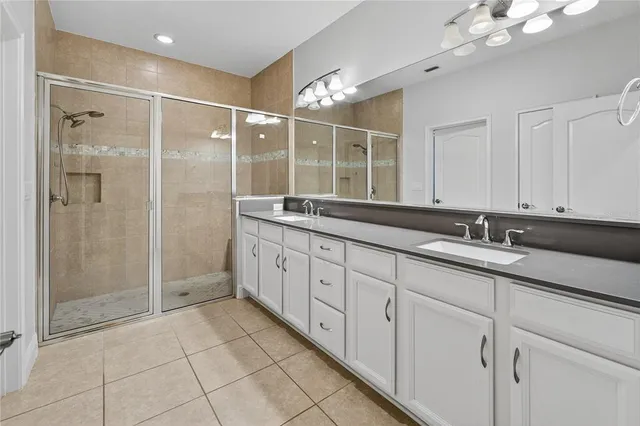 a spacious bathroom with a granite countertop sink a mirror and a
