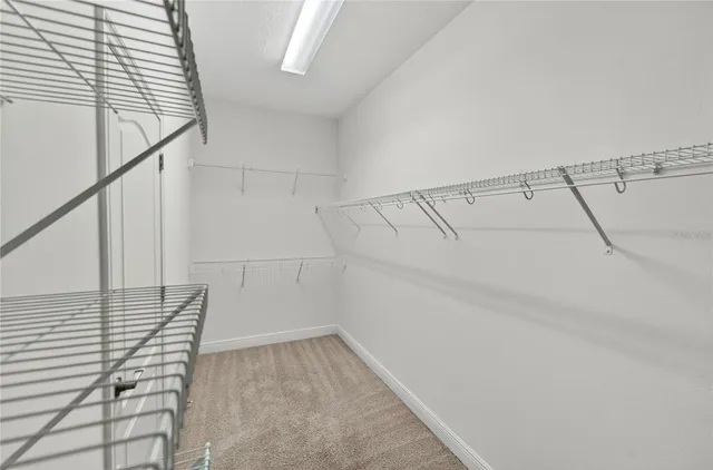 an empty room with ceiling fan and window