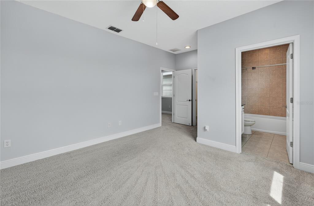 6687 Alder Road Harmony, FL 34773 - Photo 25 of 42 an empty room with ceiling fan and window