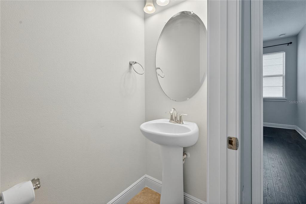 6687 Alder Road Harmony, FL 34773 - Photo 26 of 42 a bathroom with a sink and mirror