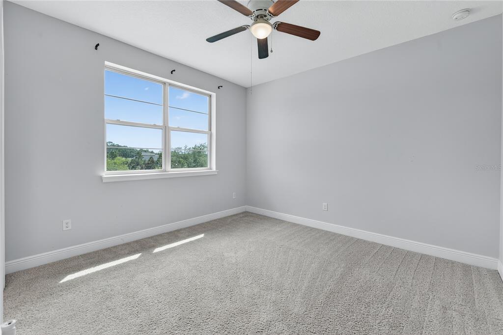 6687 Alder Road Harmony, FL 34773 - Photo 27 of 42 an empty room with a window and a fan