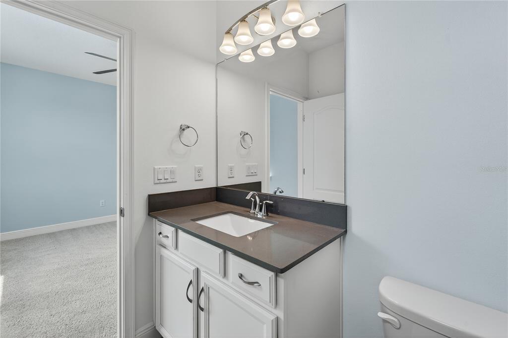 6687 Alder Road Harmony, FL 34773 - Photo 29 of 42 a bathroom with a sink vanity and a mirror