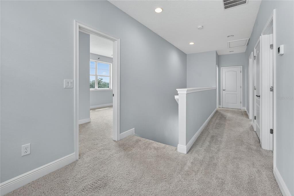 6687 Alder Road Harmony, FL 34773 - Photo 30 of 42 a view of a hallway with an empty space