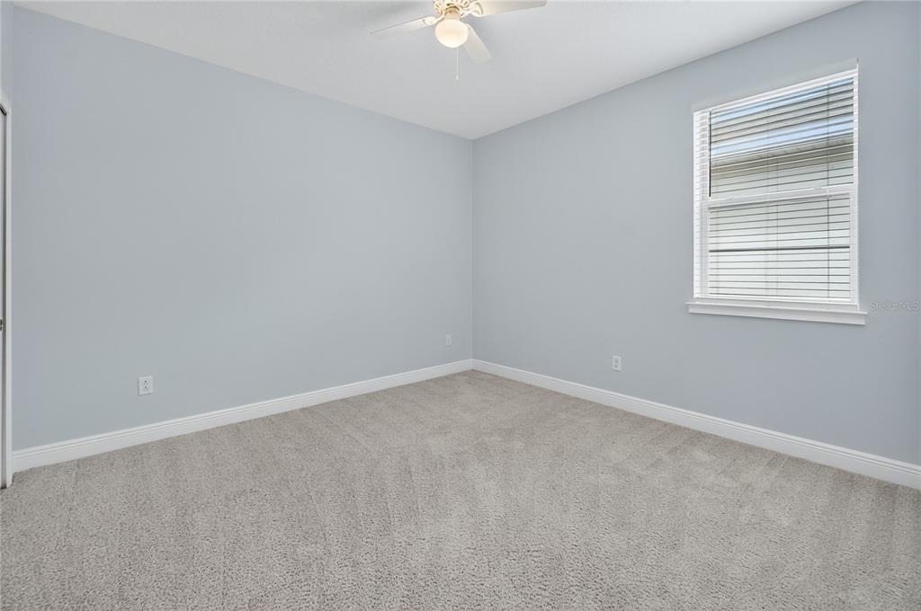 6687 Alder Road Harmony, FL 34773 - Photo 32 of 42 an empty room with a window and a fan
