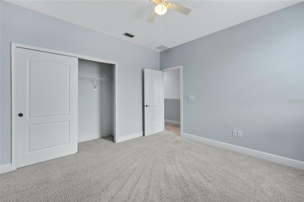 6687 Alder Road Harmony, FL 34773 - Photo 35 of 42 a view of an empty room and a chandelier fan