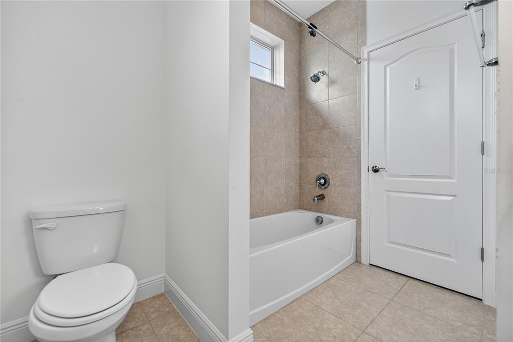 6687 Alder Road Harmony, FL 34773 - Photo 37 of 42 a white toilet sitting next to a bathtub