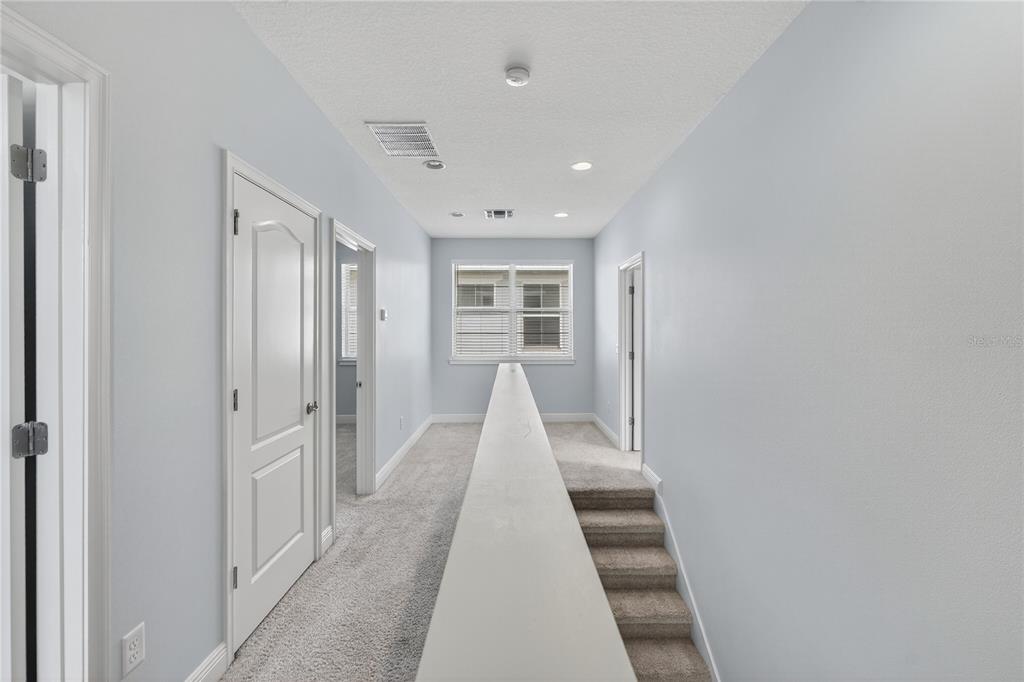 6687 Alder Road Harmony, FL 34773 - Photo 38 of 42 a view of a hallway with white walls