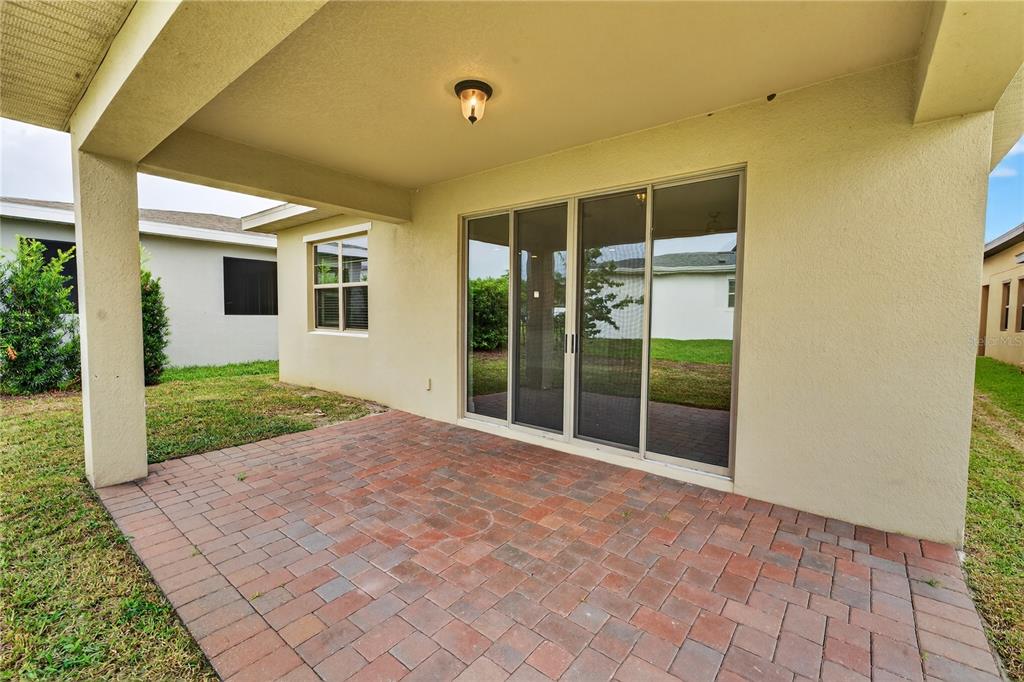 6687 Alder Road Harmony, FL 34773 - Photo 41 of 42 a view of house with backyard and glass windows