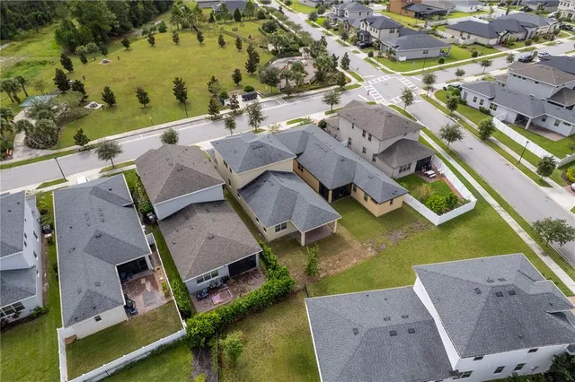 an aerial view of a house with a swimming pool and outdoor space