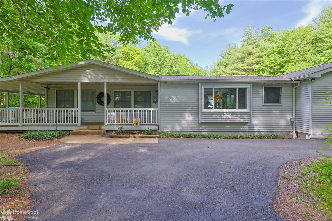 60 Sassafras Road Lehighton, PA 18235 - Photo 1 of 51 A welcoming front facade with a covered porch offers tranquil views of the surrounding woodland.